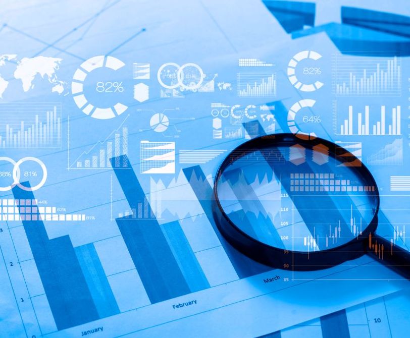 magnifying glass on top of charts